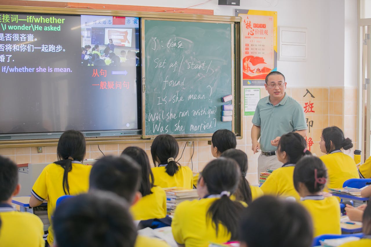 Asian teacher conducts an English lesson in a classroom with students.